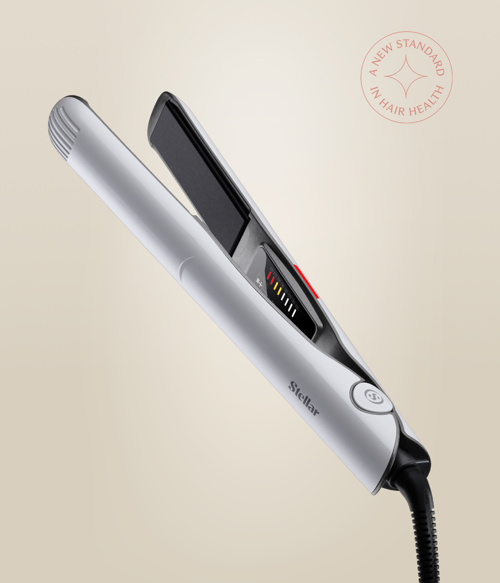 Pearl White Omnia Styler Classic open at an angle, showing its black plates, controls and cord.