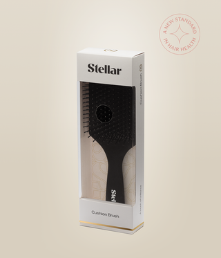Black MicroCell Cushion Brush inside a white Stellar box with a clear front window.