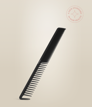 Black Carbon Cutting Comb resting at an angle, showing its fine and wide tooth sections.