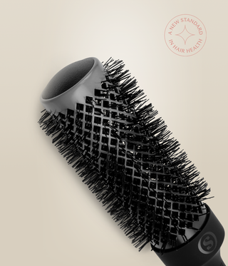 Close-up of a HeatSense Round Brush barrel, showing its open end, vents and black bristles.