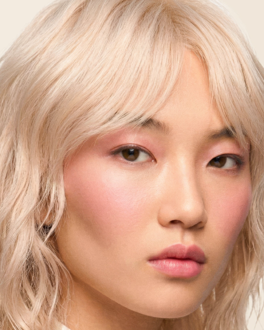 Close-up portrait with softly layered blonde hair